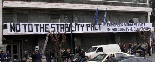 Greek trade unionist placing banner on EU offices in Athens